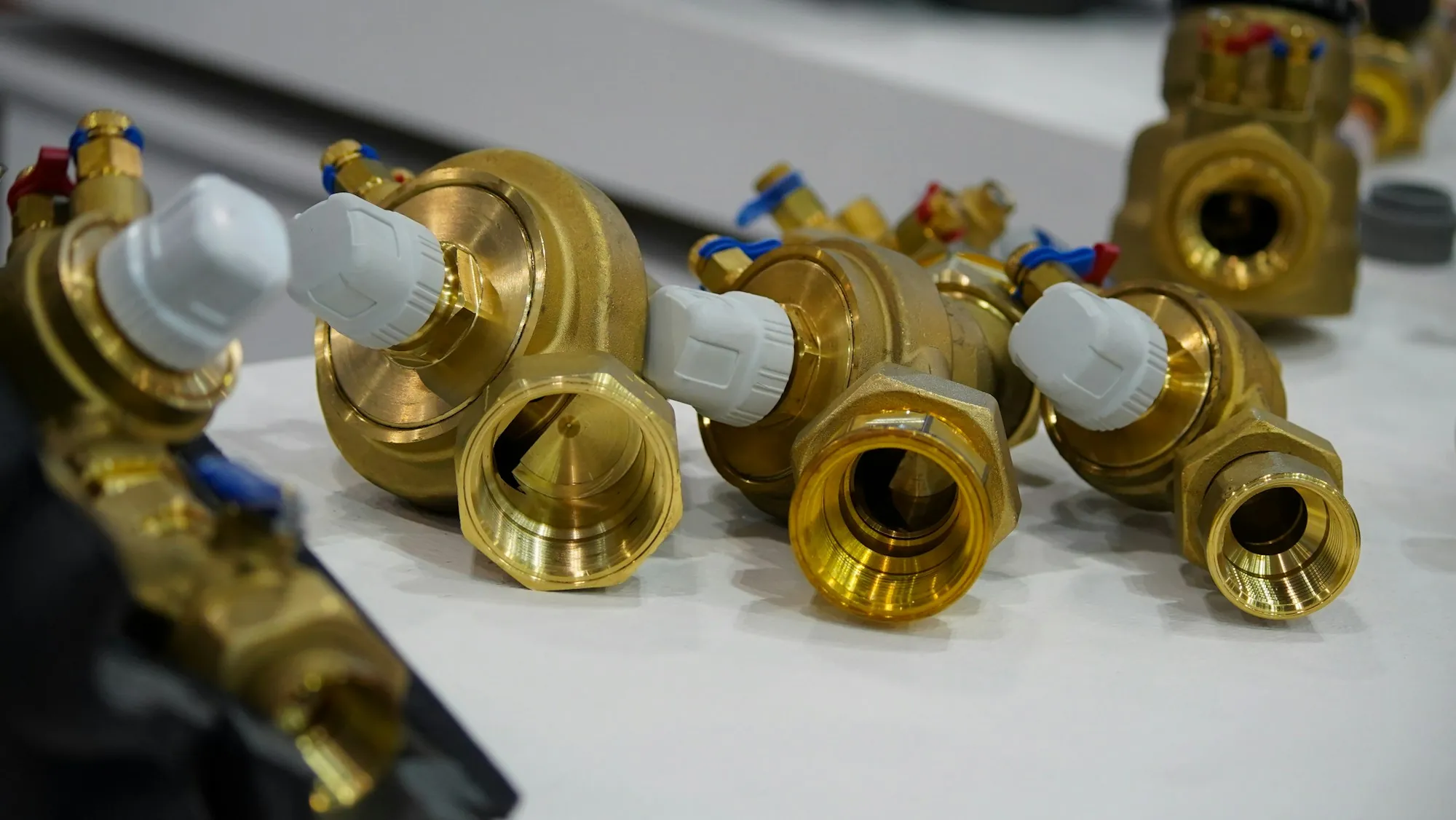 A close-up of assorted valves laid out on a bench