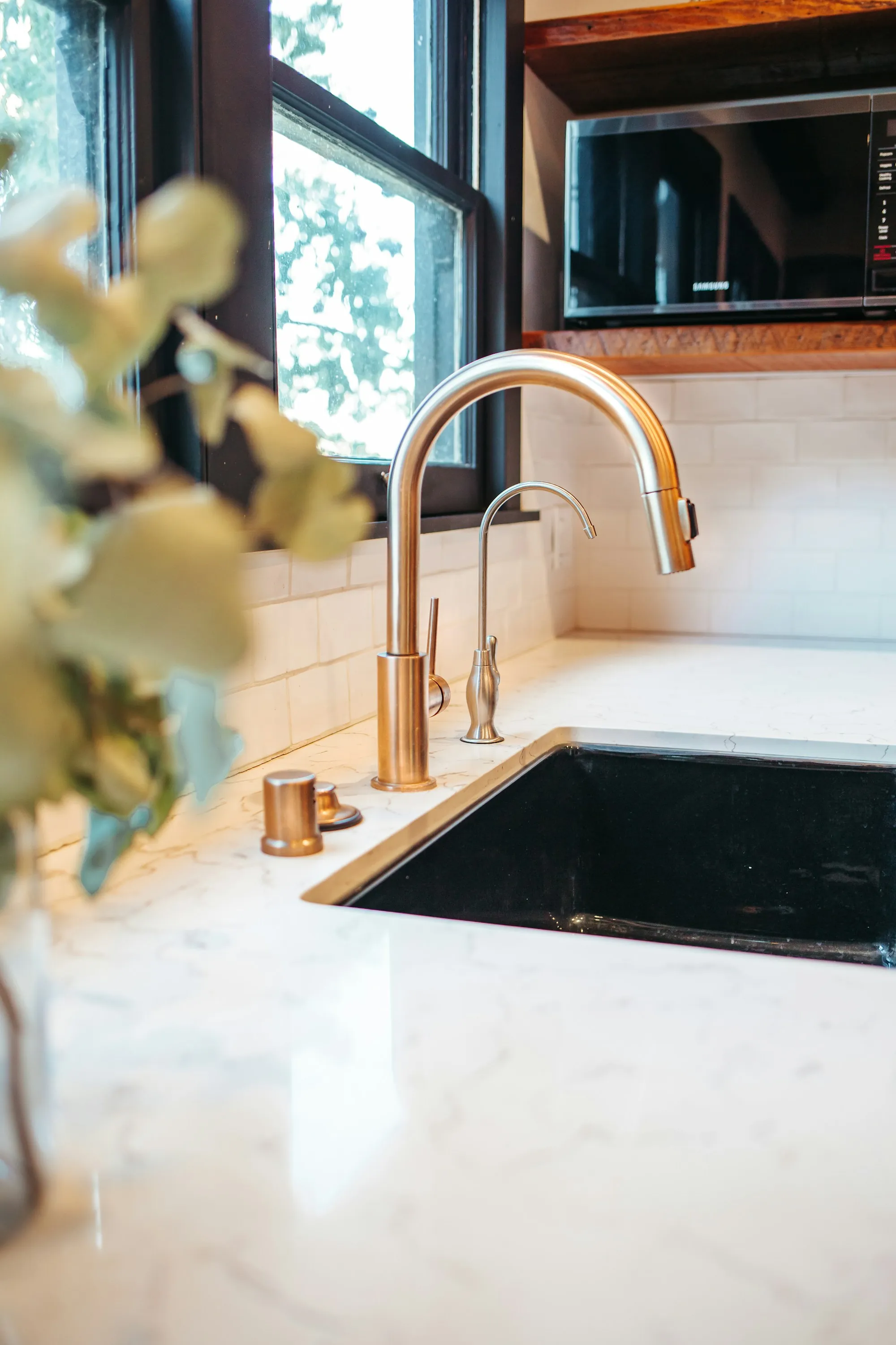 Stainless steel faucet on a white ceramic sink