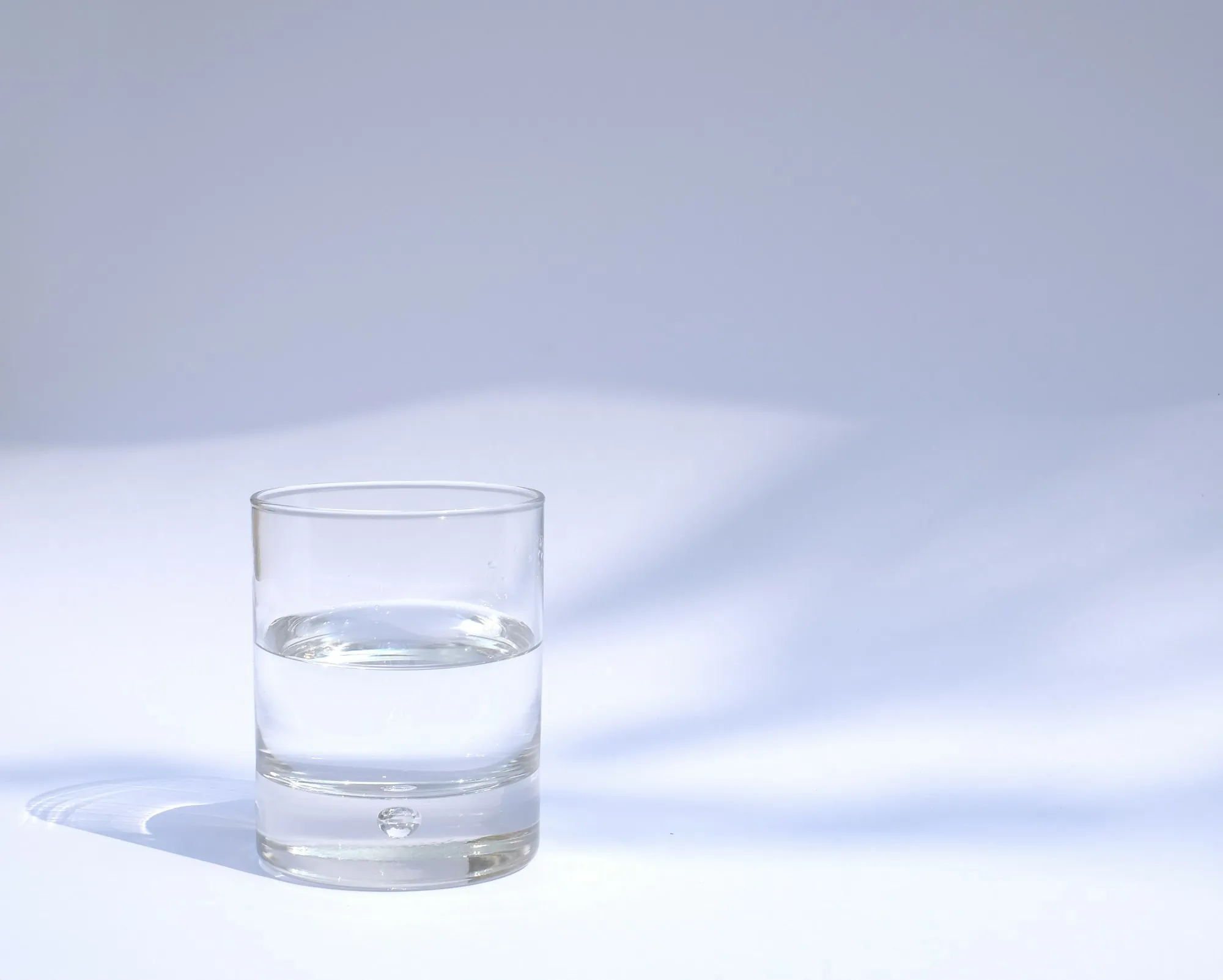 A clear drinking glass filled with water