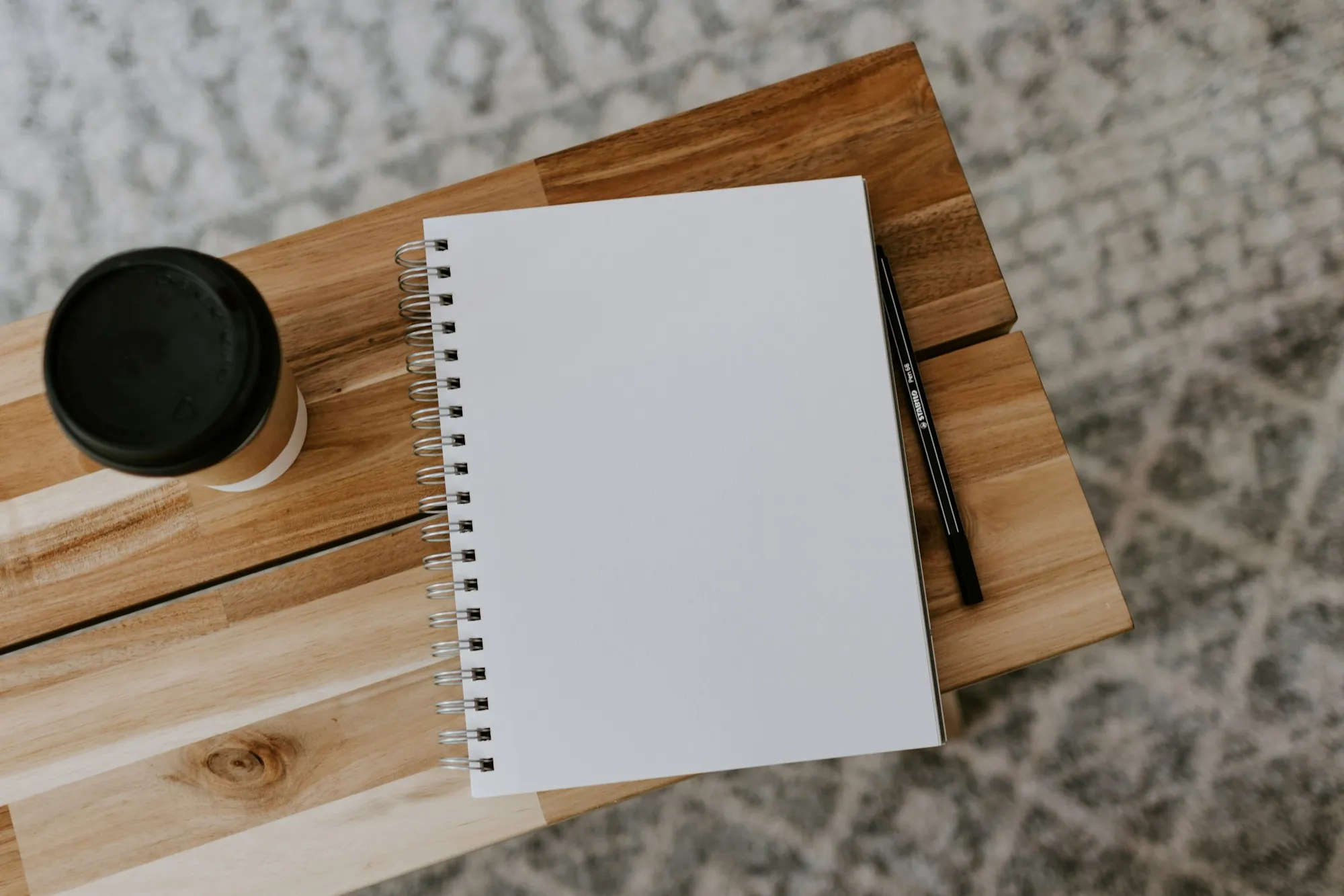 Printed pages on a brown wooden table