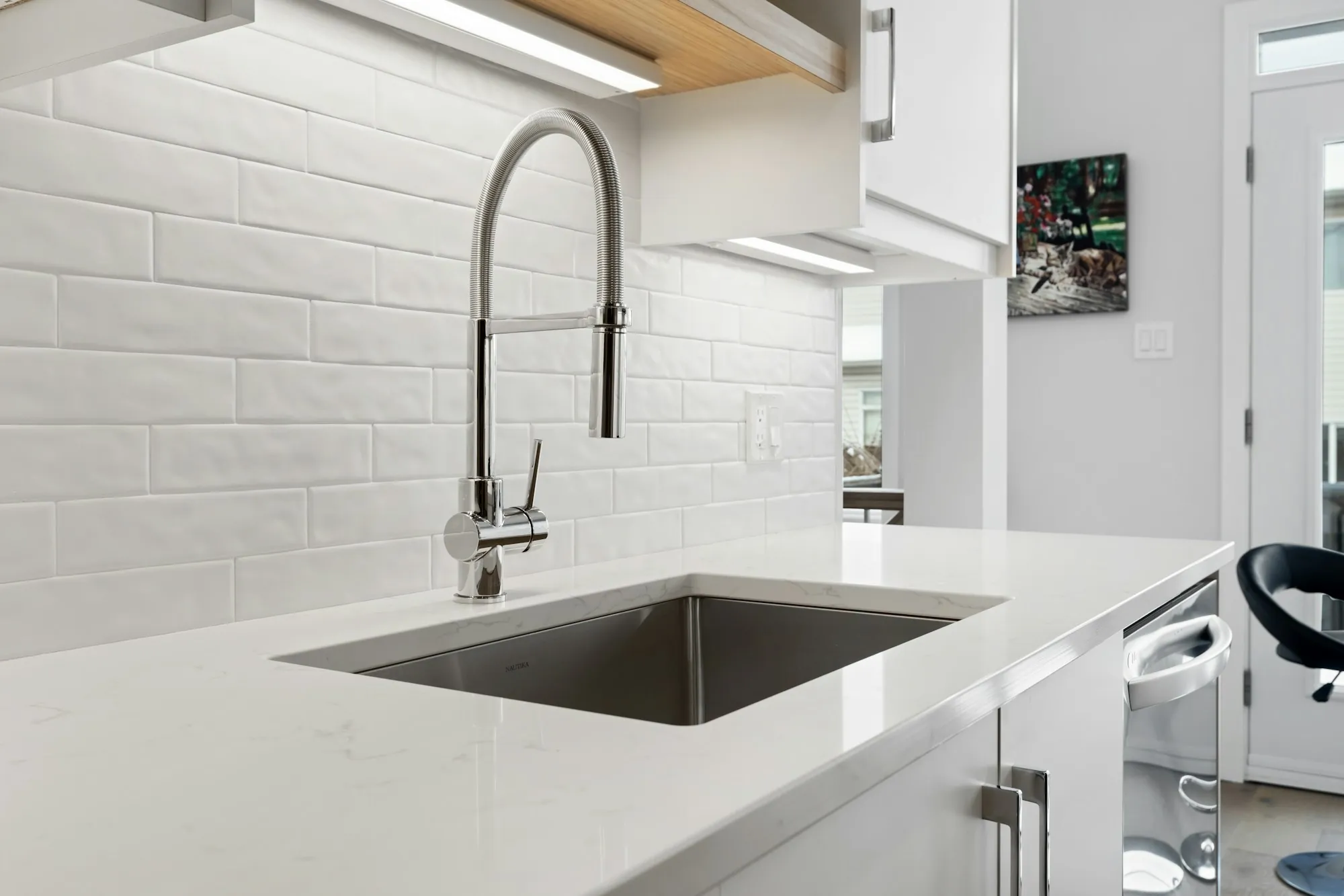 A kitchen sink beneath a window
