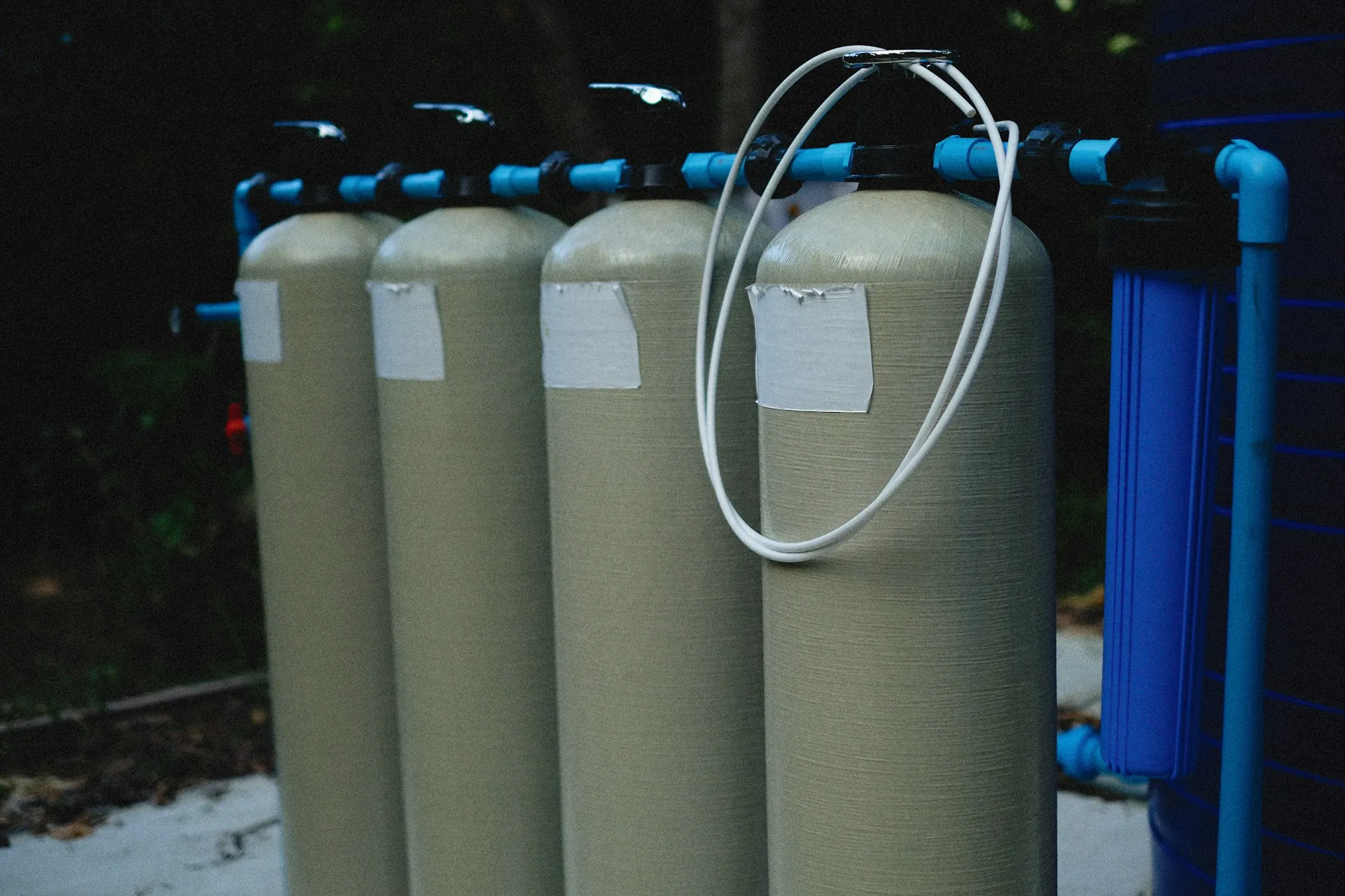 A row of water filtration housings standing side by side